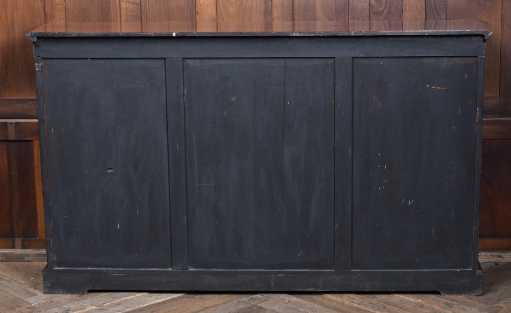A low Victorian open bookcase featuring three sections of open shelving, rich amboyna wood veneer, ebonised borders, and delicate marquetry inlays. View XIII