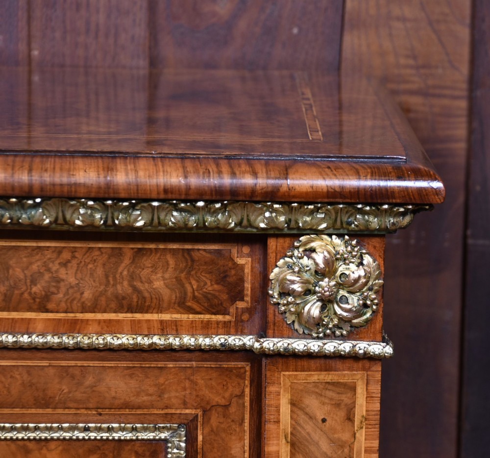 A 19th-century Victorian burr walnut side cabinet featuring two panelled doors with decorative brass mounts and a plinth base. View II