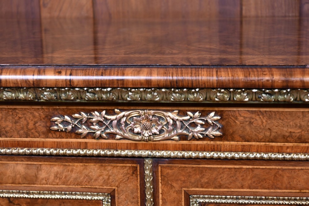 A 19th-century Victorian burr walnut side cabinet featuring two panelled doors with decorative brass mounts and a plinth base. View III