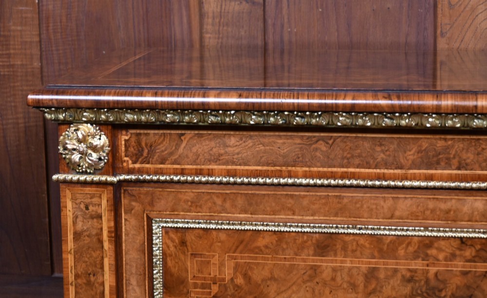 A 19th-century Victorian burr walnut side cabinet featuring two panelled doors with decorative brass mounts and a plinth base. View VII