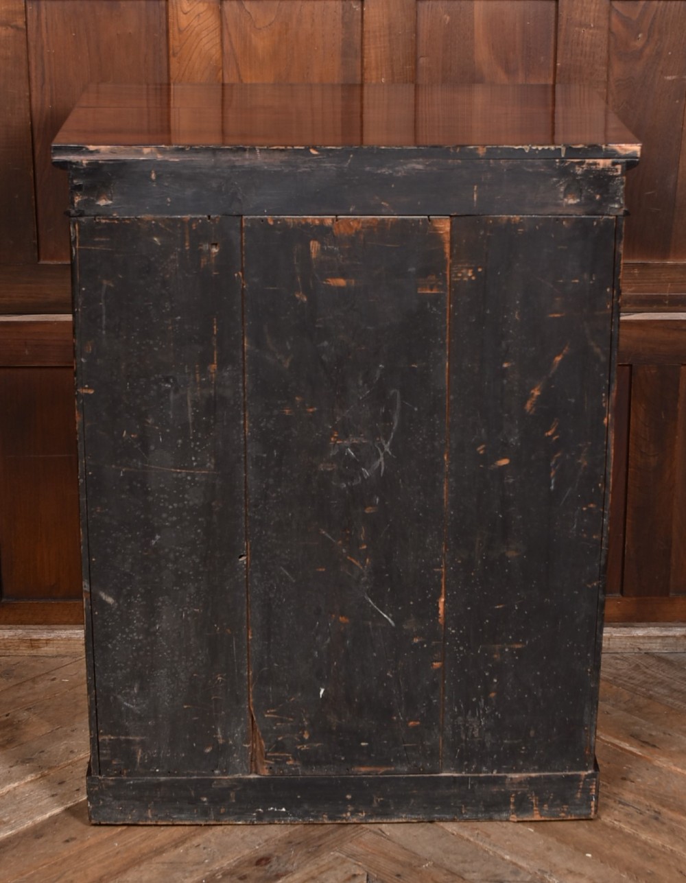 A tall Victorian rosewood Wellington chest featuring six graduated drawers with turned wooden knobs, carved corbels, and a right-side locking bar. View XI