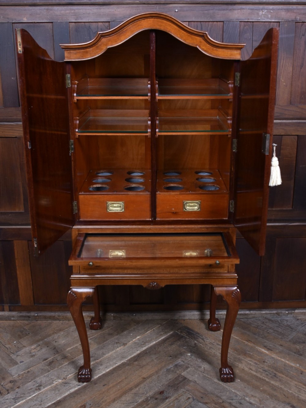 An Edwardian mahogany drinks cabinet on stand featuring chevron-matched wood veneer doors, a lower drawer with brass drop handles, and carved cabriole legs ending in ball and claw feet. View V