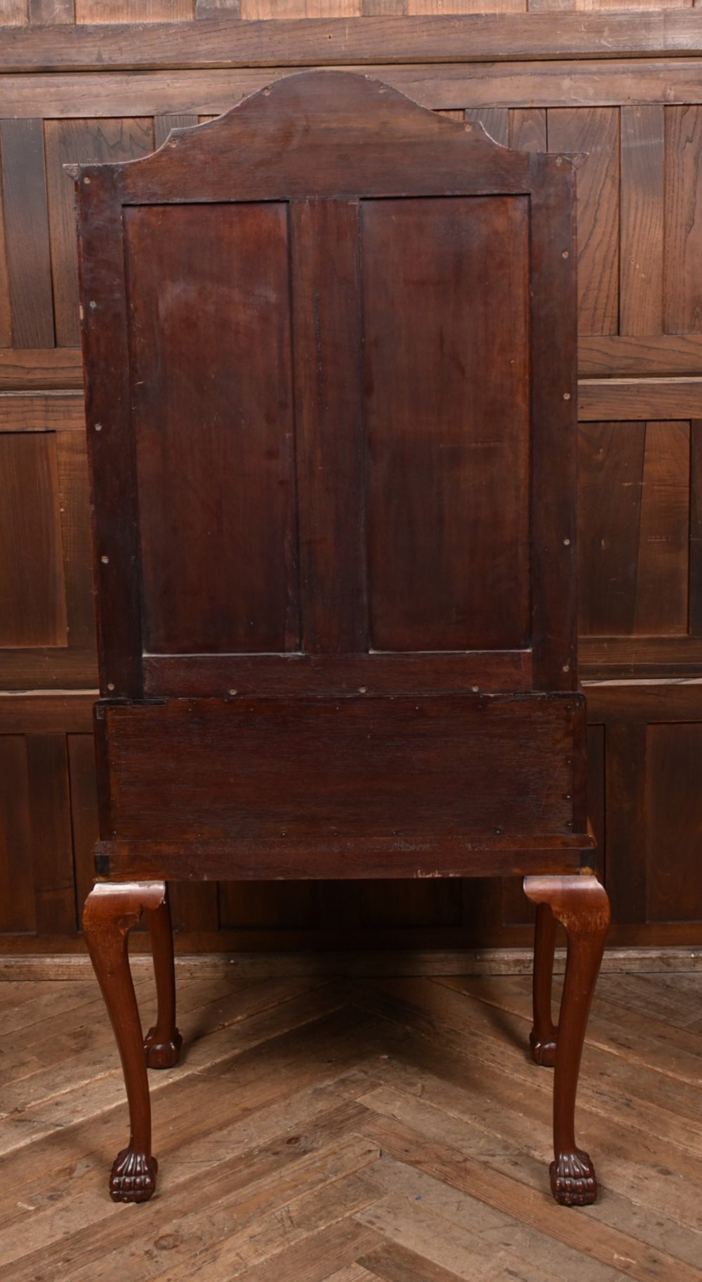 An Edwardian mahogany drinks cabinet on stand featuring chevron-matched wood veneer doors, a lower drawer with brass drop handles, and carved cabriole legs ending in ball and claw feet. View X