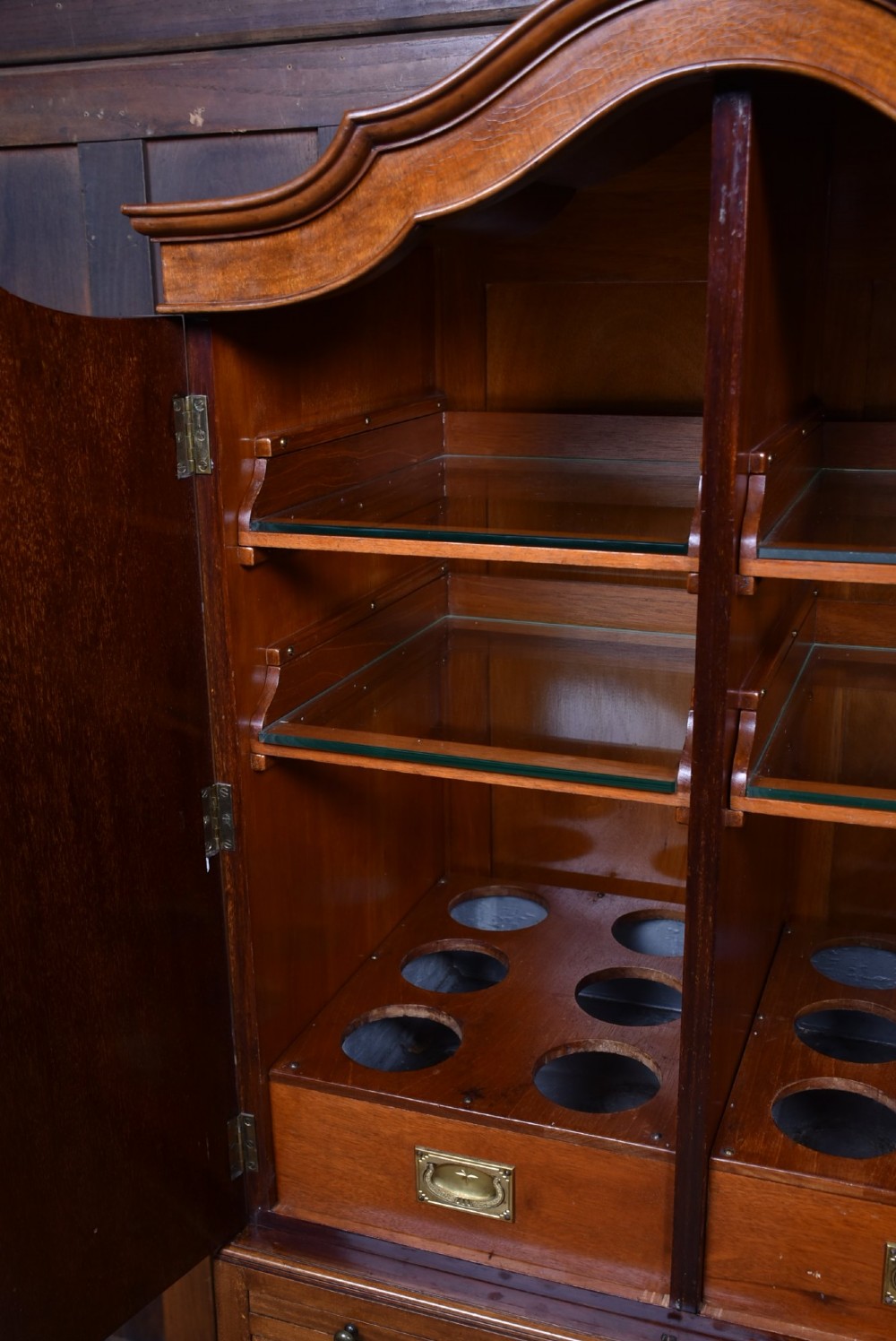 An Edwardian mahogany drinks cabinet on stand featuring chevron-matched wood veneer doors, a lower drawer with brass drop handles, and carved cabriole legs ending in ball and claw feet. View XII