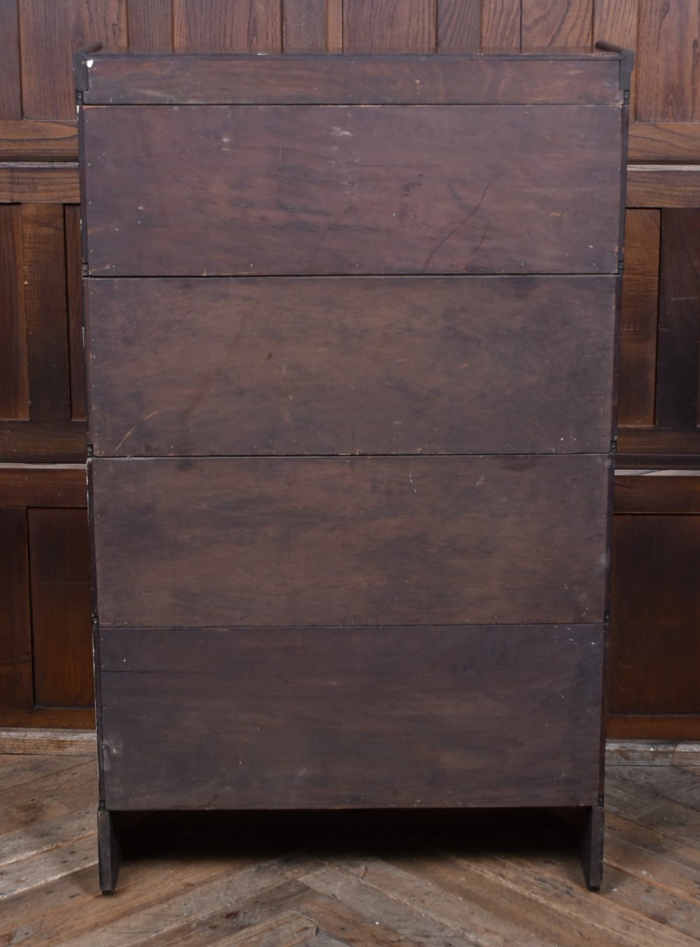 An Edwardian dark oak four-tier Globe Wernicke sectional bookcase featuring glass up-and-over doors and brass maker labels. View XI