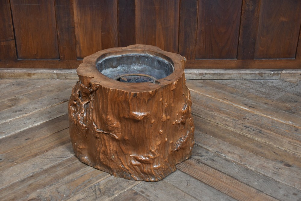 A carved wooden tree-stump hibachi featuring a hollowed centre with a copper lining and iron trivet. View III