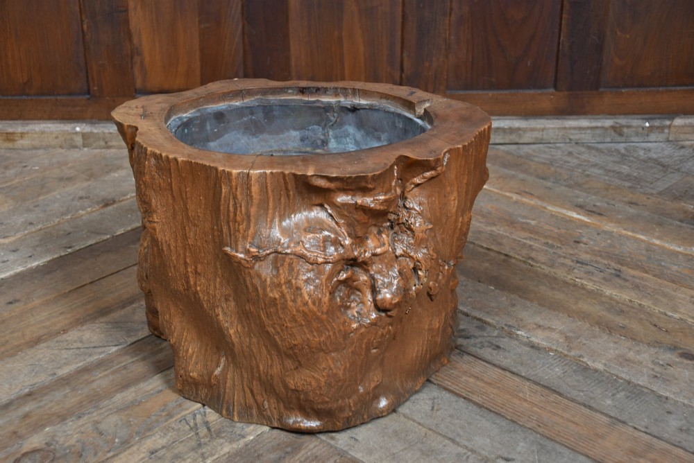 A carved wooden tree-stump hibachi featuring a hollowed centre with a copper lining and iron trivet. View IV