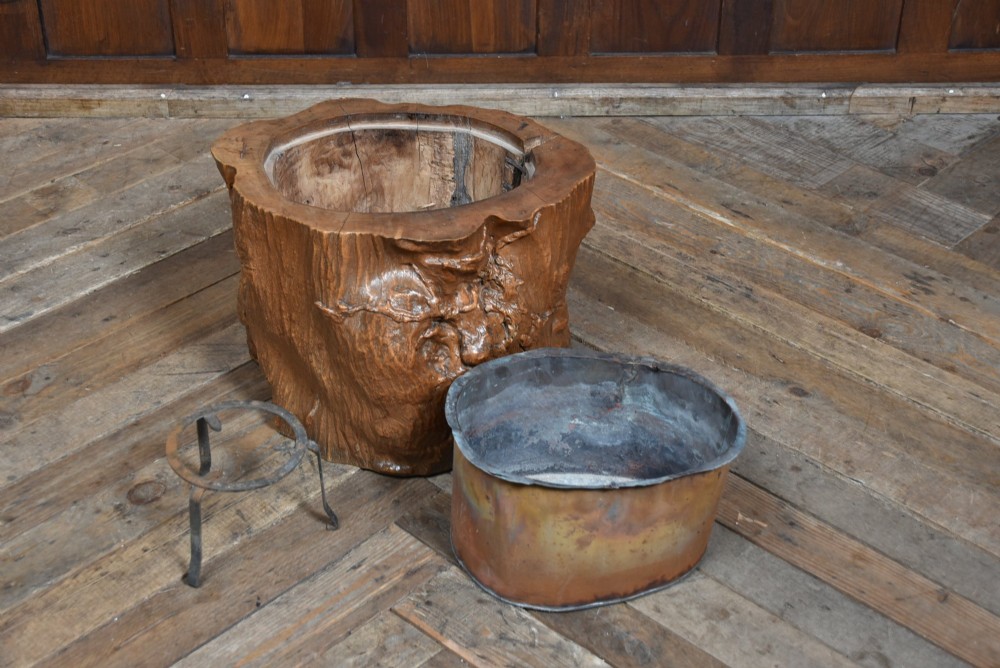A carved wooden tree-stump hibachi featuring a hollowed centre with a copper lining and iron trivet. View V