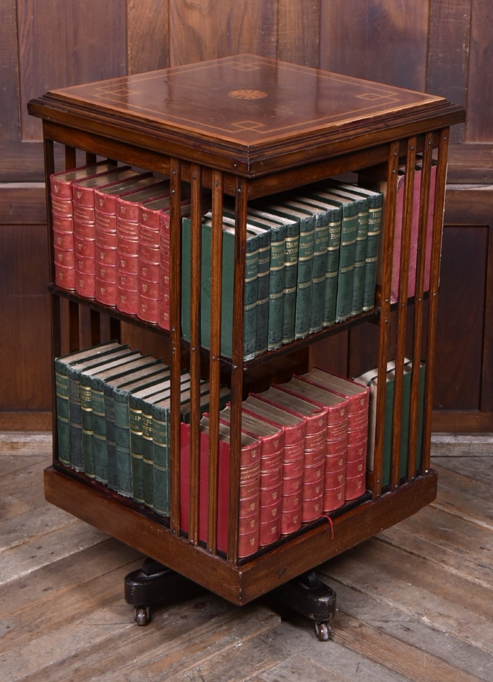 An Edwardian mahogany two-tier revolving bookcase with vertical slatted sides, satinwood top inlay, and a rotating cast-iron base. View III