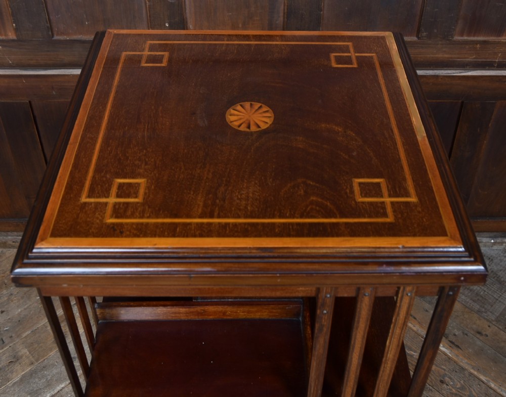 An Edwardian mahogany two-tier revolving bookcase with vertical slatted sides, satinwood top inlay, and a rotating cast-iron base. View VI