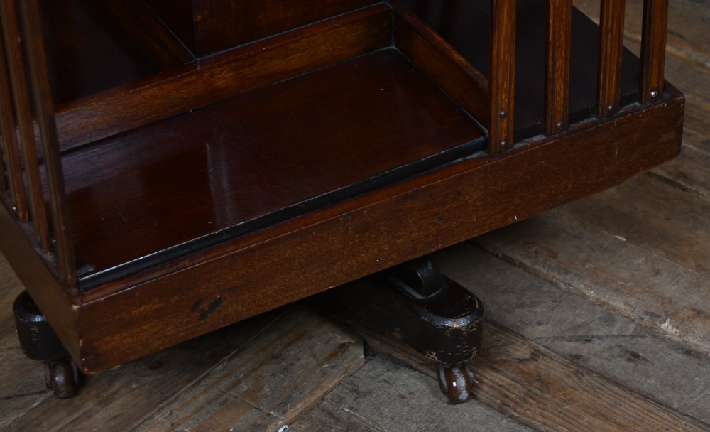 An Edwardian mahogany two-tier revolving bookcase with vertical slatted sides, satinwood top inlay, and a rotating cast-iron base. View VII