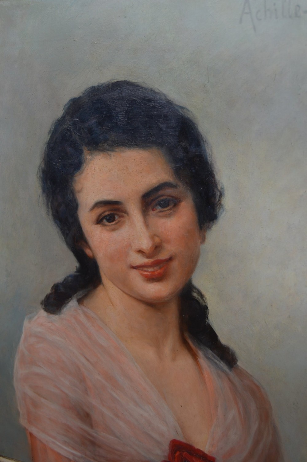 An antique oil painting on canvas depicting a portrait of a dark-haired woman in a soft pink shawl with a red rose, set within an ornate carved gilt frame. View III