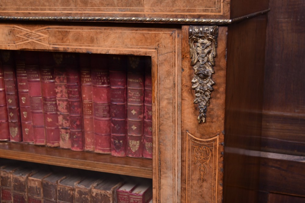 A Victorian burr walnut low cabinet featuring two glazed doors, intricate boxwood inlay, and ornate bronzed corner mounts. View II