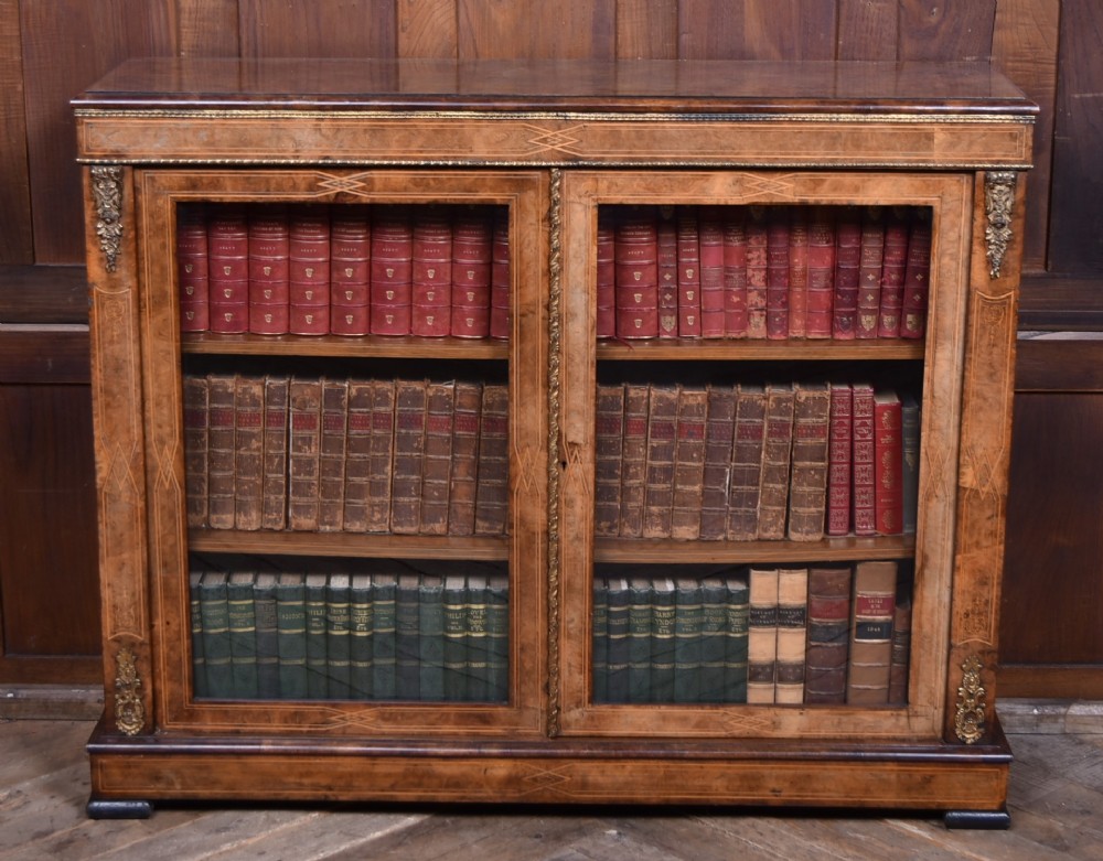 A Victorian burr walnut low cabinet featuring two glazed doors, intricate boxwood inlay, and ornate bronzed corner mounts. View III
