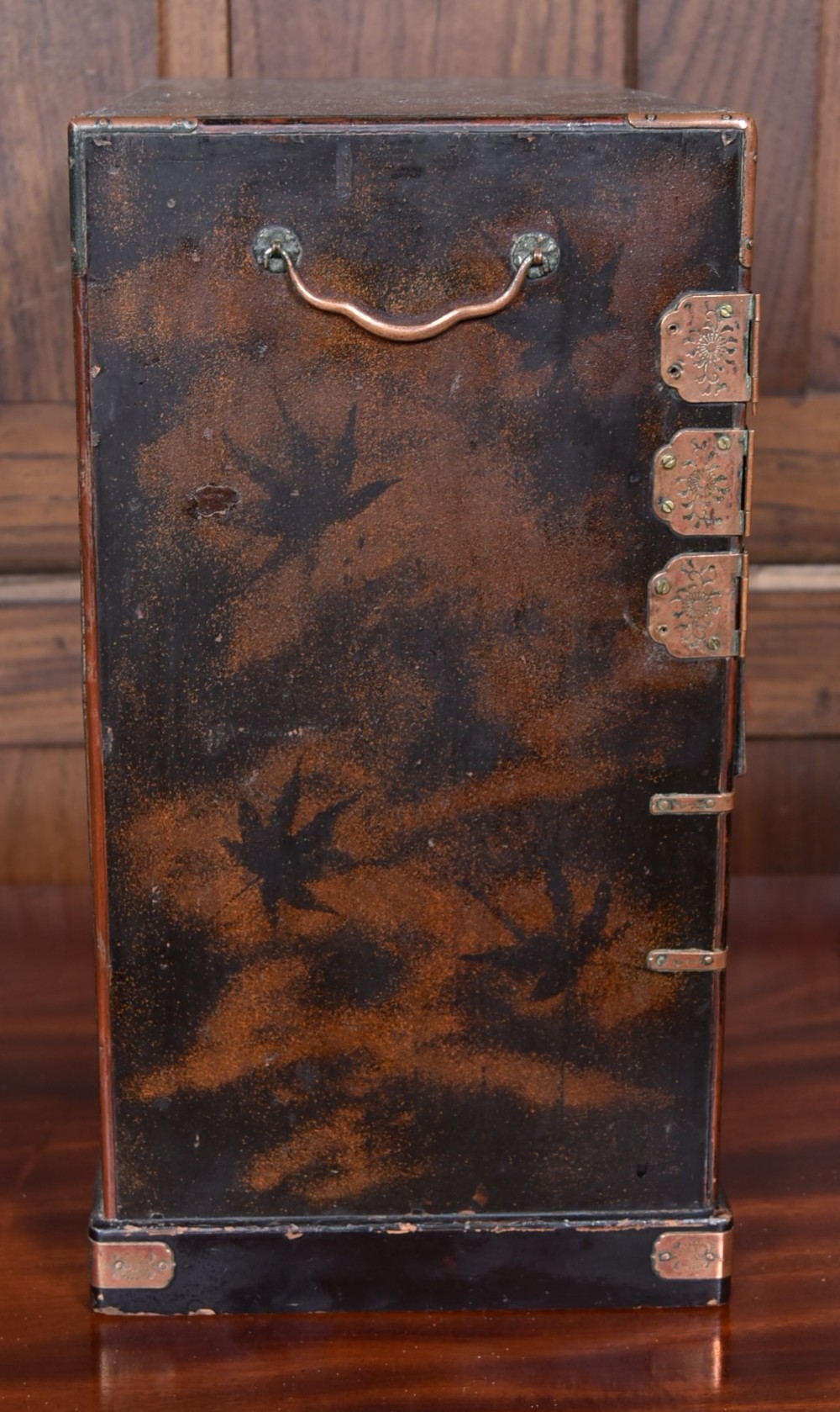 A Japanese tabletop wooden kodansu cabinet featuring geometric marquetry, mother-of-pearl shell inlay on dark lacquered door panels, metal mounts, and lower drawers. View VIII