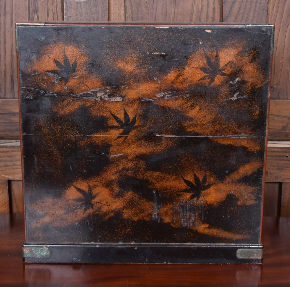 A Japanese tabletop wooden kodansu cabinet featuring geometric marquetry, mother-of-pearl shell inlay on dark lacquered door panels, metal mounts, and lower drawers. View IX