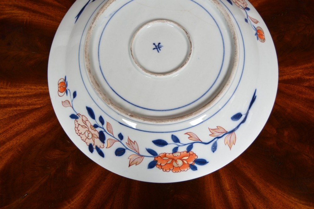 A circular Japanese Imari porcelain plate decorated in cobalt blue, iron-red, and gold floral patterns around a central floral roundel. View VII