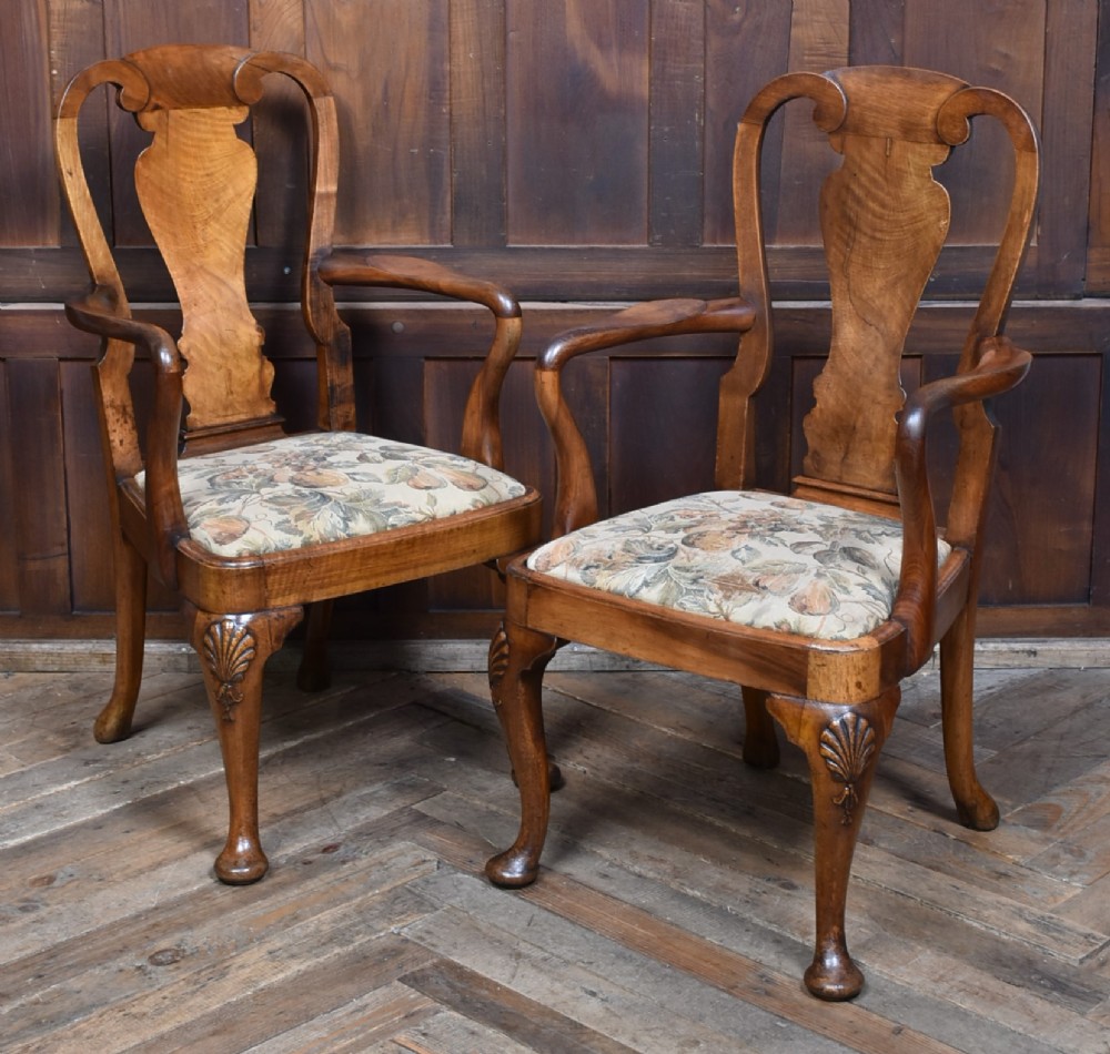 A pair of Victorian Queen Anne style walnut armchairs featuring vase-shaped back splats, carved cabriole legs, and floral patterned drop-in seats. View II