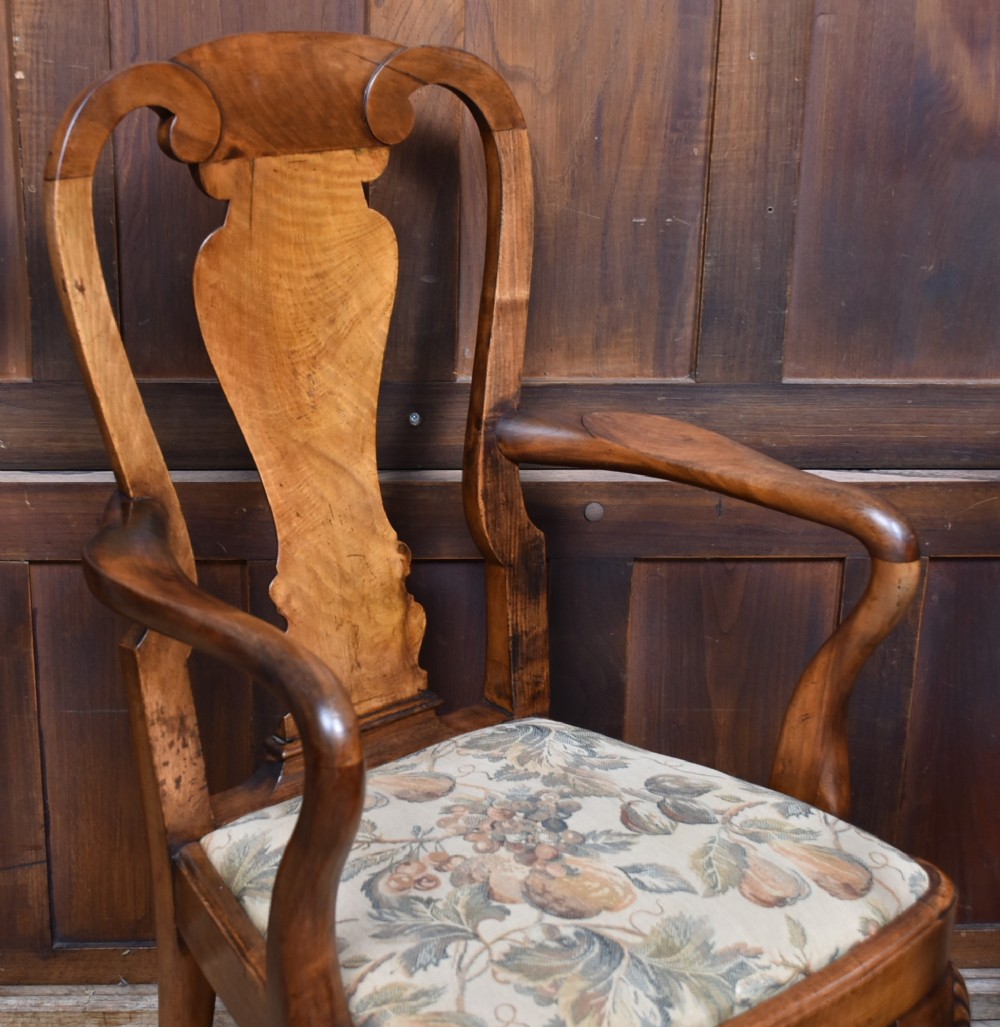 A pair of Victorian Queen Anne style walnut armchairs featuring vase-shaped back splats, carved cabriole legs, and floral patterned drop-in seats. View IV