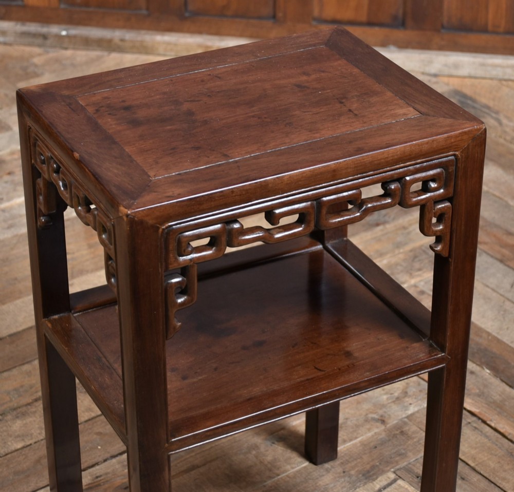 A dark hardwood Chinese vase table featuring a square top, carved fretwork apron, open lower shelf, and straight square legs. View VIII