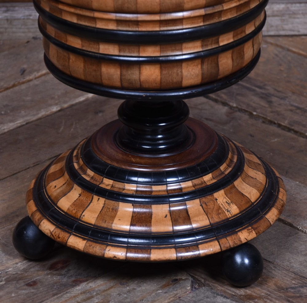 A 19th-century Dutch wooden teestoof featuring alternating light and dark wood parquetry, ebonised trim, turned pedestal base on ball feet, and a removable brass liner with a swing handle. View III