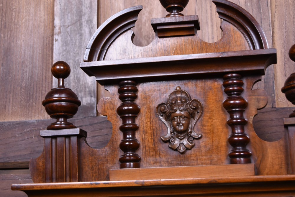 A late 19th-century Vienna-style wall clock featuring a dark walnut carved wood case, turned side columns, decorative pediment, brass weights, and a brass pendulum. View III