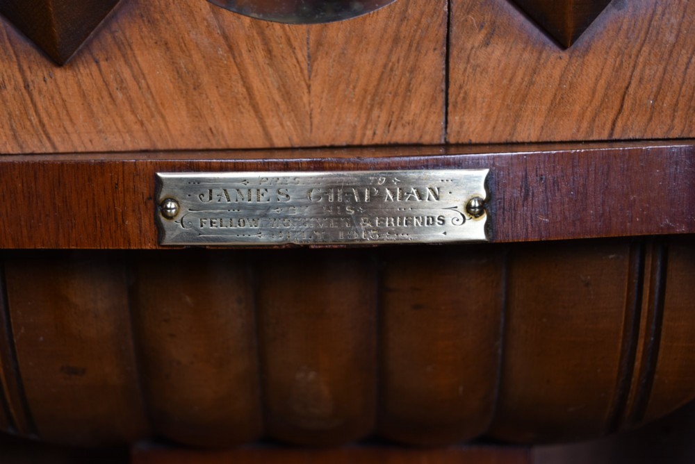 A late 19th-century Vienna-style wall clock featuring a dark walnut carved wood case, turned side columns, decorative pediment, brass weights, and a brass pendulum. View VIII