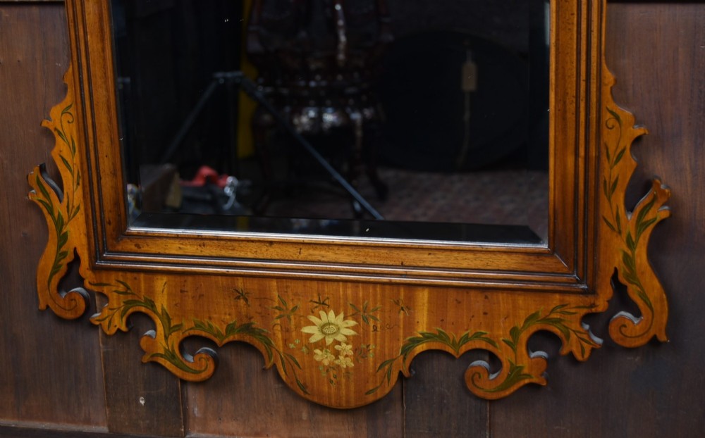 An Edwardian walnut wall mirror featuring a carved fretwork border, a painted floral oval crest, and marquetry leaf scroll details framing a central rectangular glass plate. View IV