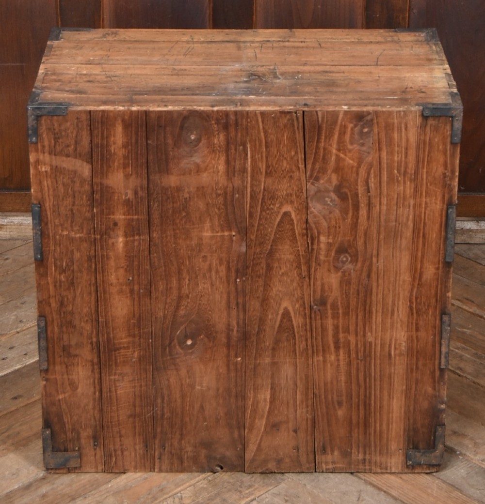 A traditional wooden Japanese tansu chest featuring four tiers of drawers accented with dark iron handles and corner brackets. View IX