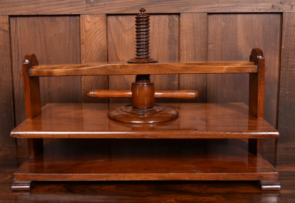 A Victorian mahogany tabletop book press featuring a wooden central screw thread, turned crossbar handles, and a polished base. View II