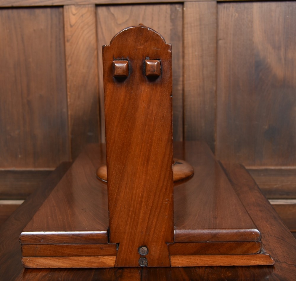 A Victorian mahogany tabletop book press featuring a wooden central screw thread, turned crossbar handles, and a polished base. View VIII
