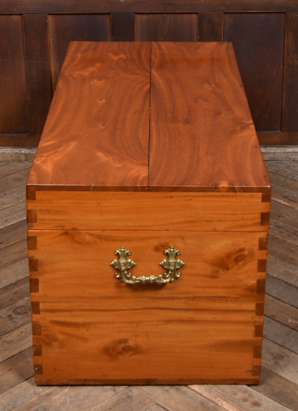 A rectangular warm amber camphor wood blanket box featuring exposed dovetail corner joints and metal side handles. View VIII