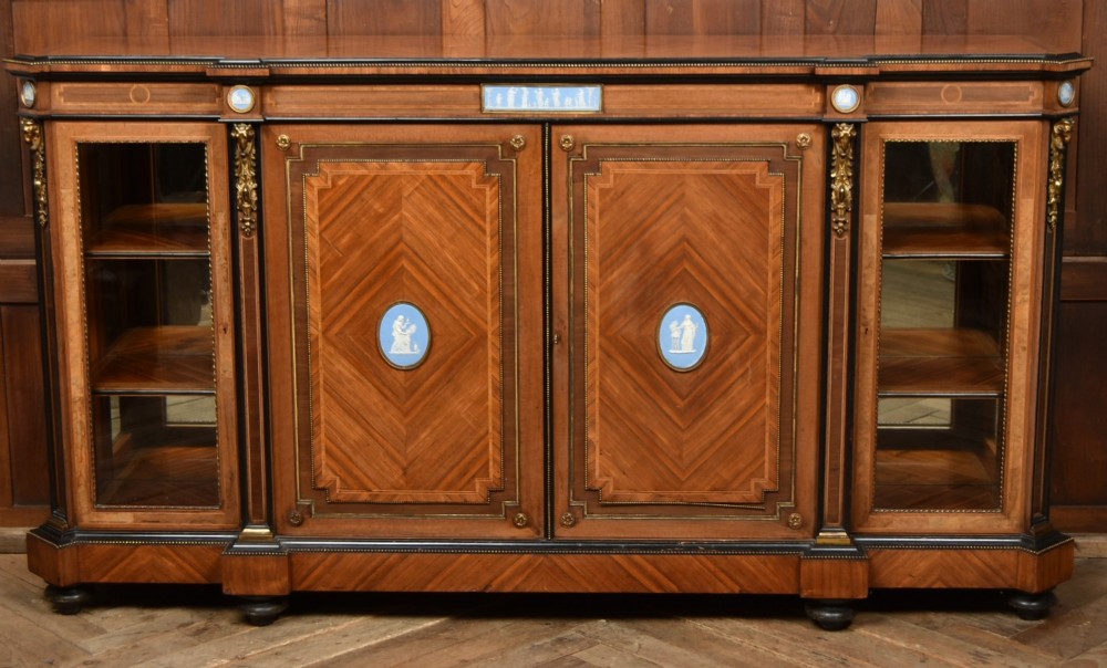 A Victorian inlaid rosewood credenza sideboard featuring central parquetry doors adorned with blue jasperware plaques, flanked by two glass-fronted side display cabinets.