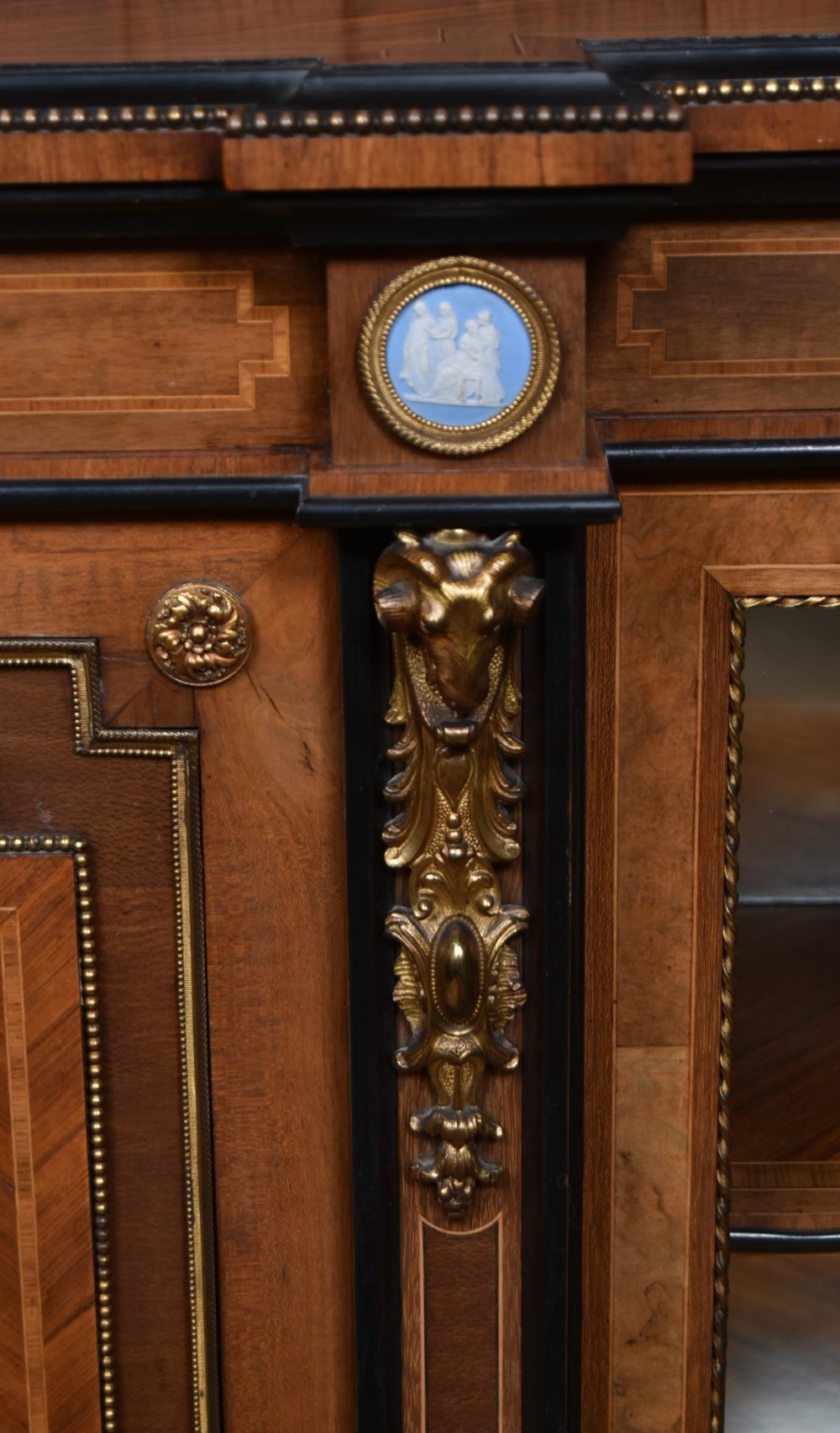 A Victorian inlaid rosewood credenza sideboard featuring central parquetry doors adorned with blue jasperware plaques, flanked by two glass-fronted side display cabinets. View III