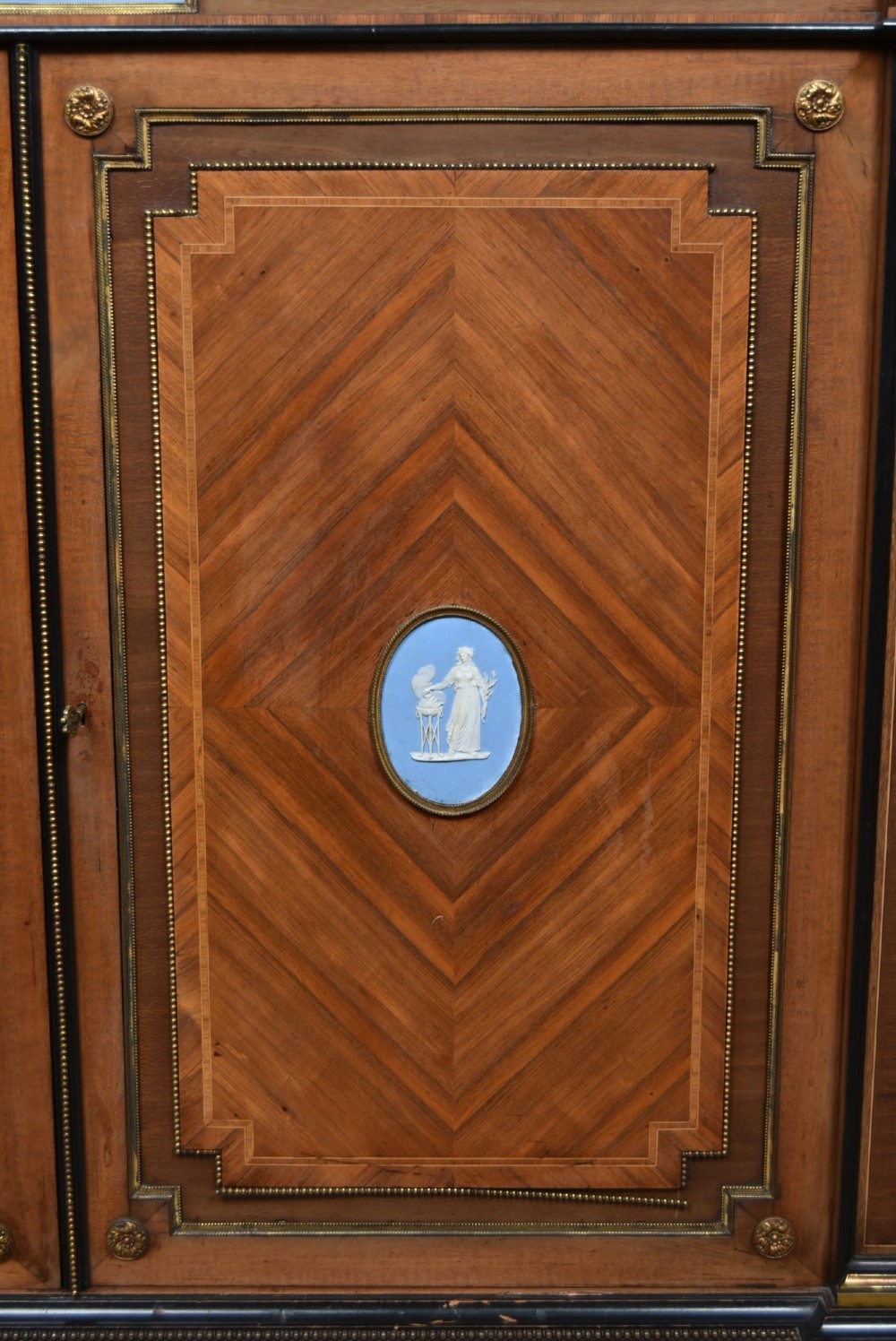 A Victorian inlaid rosewood credenza sideboard featuring central parquetry doors adorned with blue jasperware plaques, flanked by two glass-fronted side display cabinets. View IV