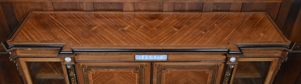 A Victorian inlaid rosewood credenza sideboard featuring central parquetry doors adorned with blue jasperware plaques, flanked by two glass-fronted side display cabinets. View VIII