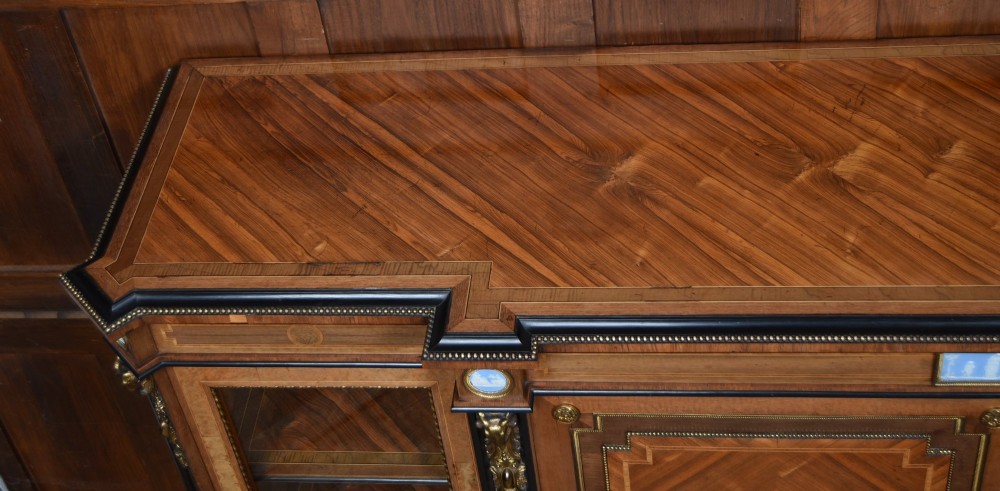 A Victorian inlaid rosewood credenza sideboard featuring central parquetry doors adorned with blue jasperware plaques, flanked by two glass-fronted side display cabinets. View IX