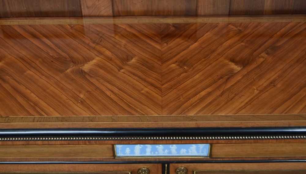 A Victorian inlaid rosewood credenza sideboard featuring central parquetry doors adorned with blue jasperware plaques, flanked by two glass-fronted side display cabinets. View XI