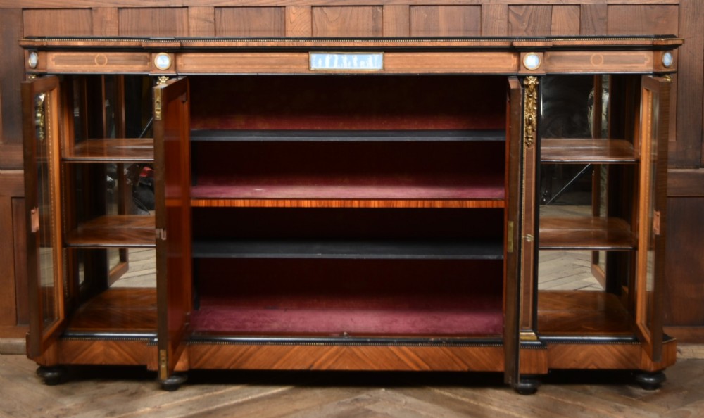 A Victorian inlaid rosewood credenza sideboard featuring central parquetry doors adorned with blue jasperware plaques, flanked by two glass-fronted side display cabinets. View XII