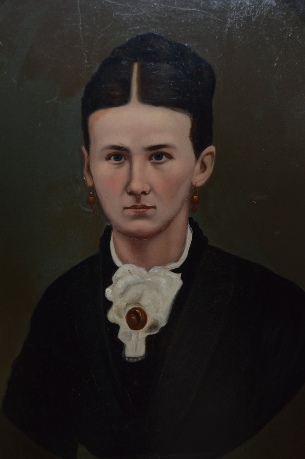 A pair of 19th-century oil portrait paintings depicting a man and a woman in black clothing, housed in matching gold gilded frames. View VI