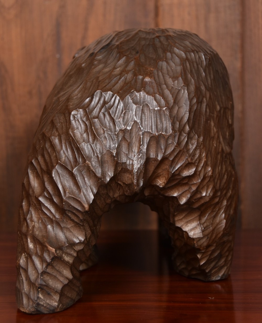 A hand-carved dark wood bear sculpture featuring detailed gouged fur texture and an open mouth. View VI