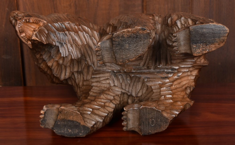 A hand-carved dark wood bear sculpture featuring detailed gouged fur texture and an open mouth. View VII