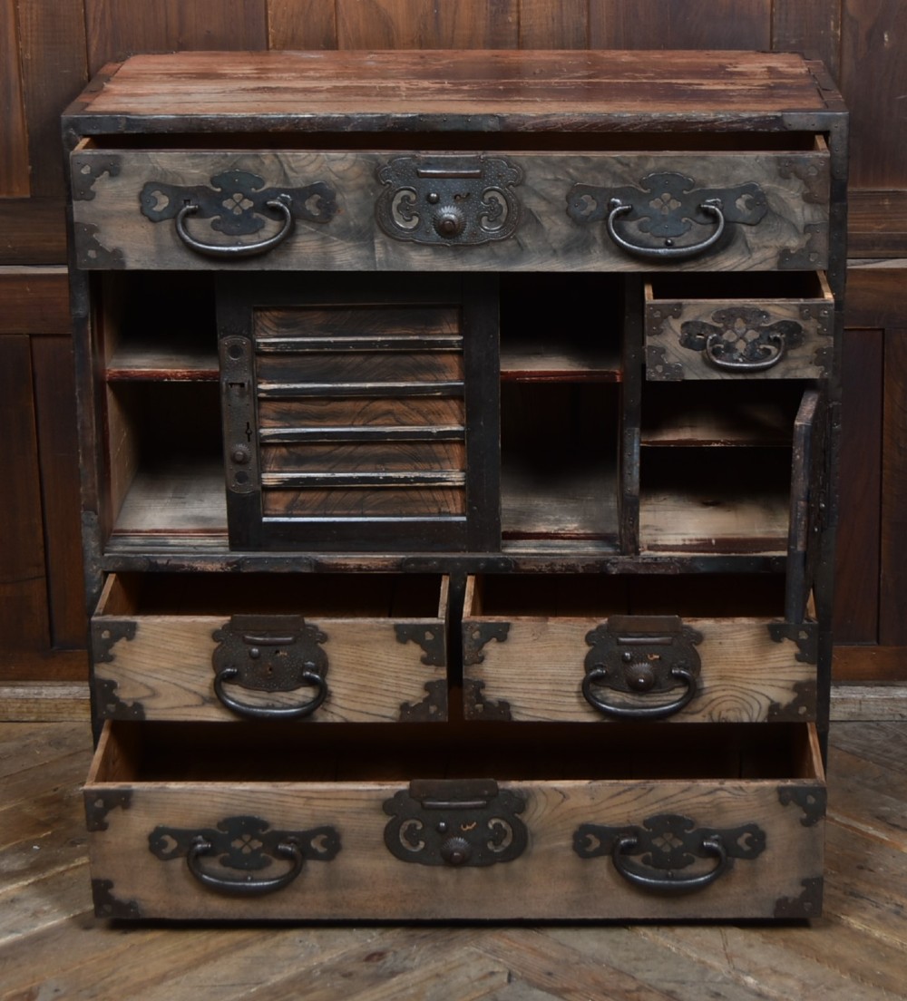 A Japanese tansu wooden chest featuring multiple drawers, sliding louvered doors, a small lockable door, and dark iron corner plates and drop handles. View VIII
