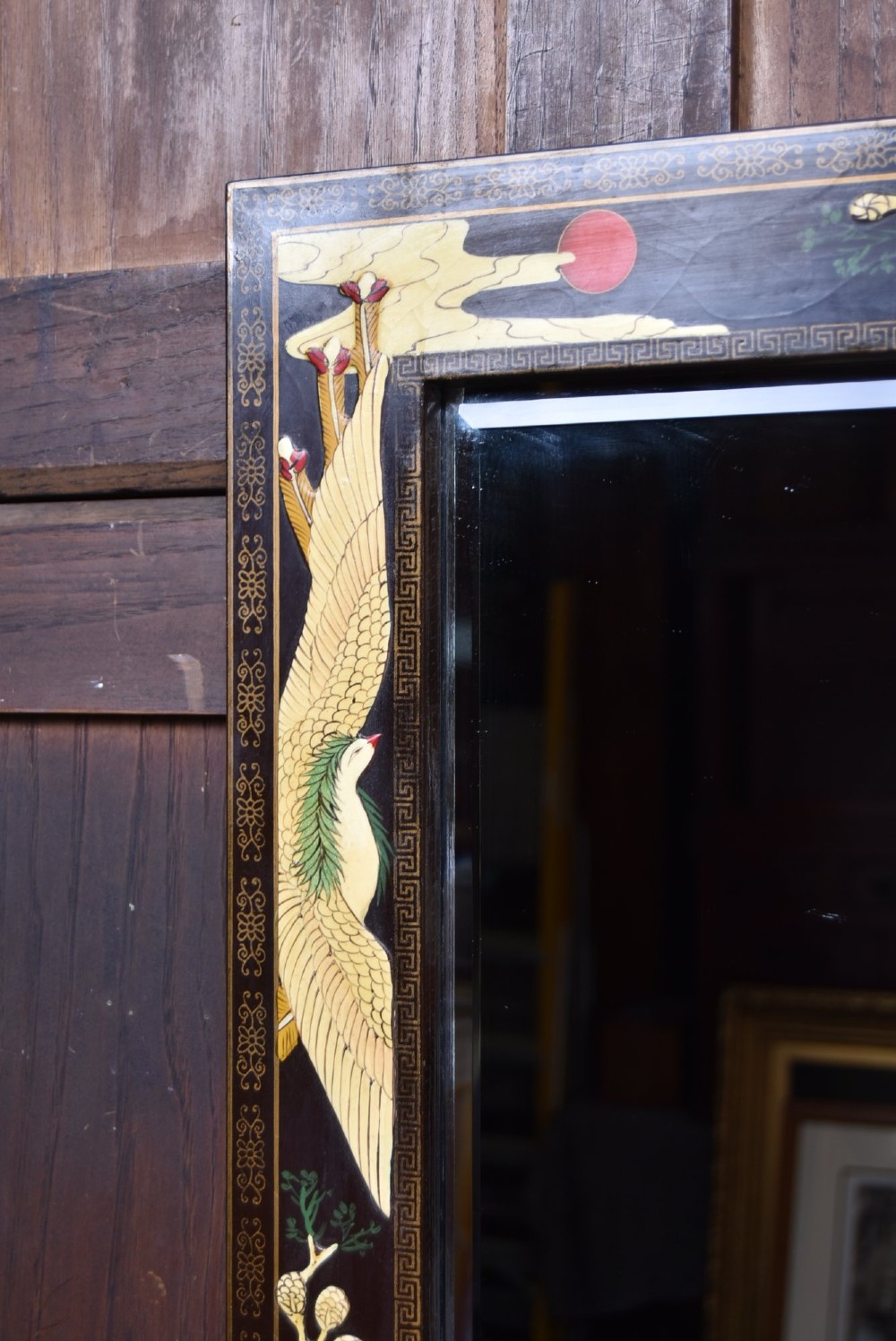 A tall black lacquered rectangular wall mirror featuring an integrated bottom shelf and painted borders with cranes, lotus blossoms, and botanical details. View III