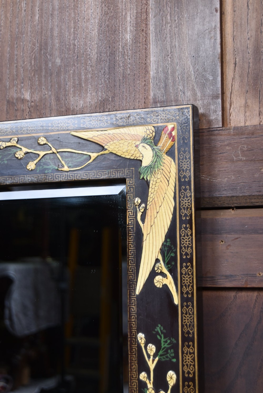 A tall black lacquered rectangular wall mirror featuring an integrated bottom shelf and painted borders with cranes, lotus blossoms, and botanical details. View IV