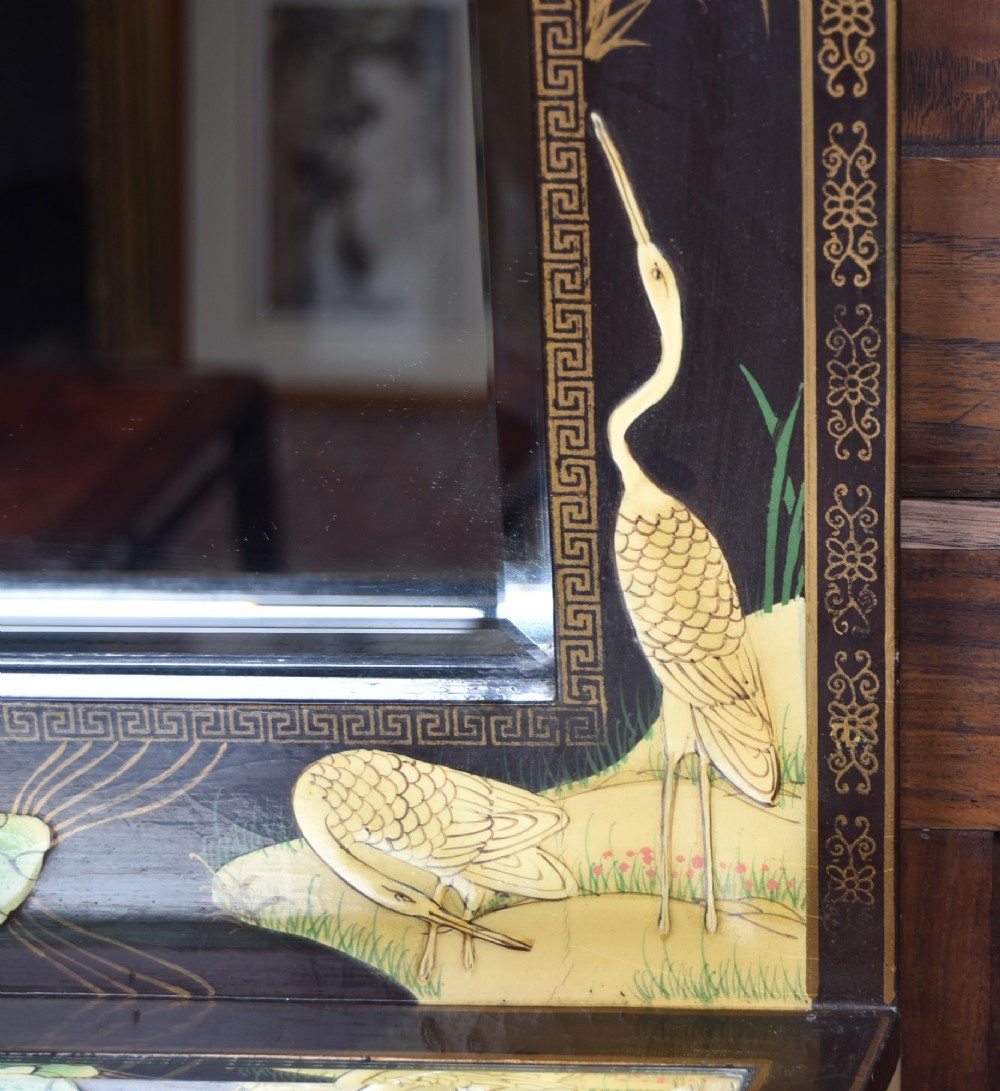 A tall black lacquered rectangular wall mirror featuring an integrated bottom shelf and painted borders with cranes, lotus blossoms, and botanical details. View V