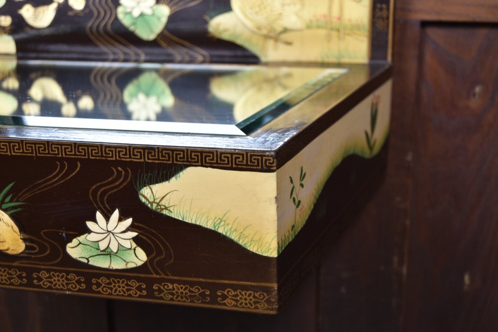 A tall black lacquered rectangular wall mirror featuring an integrated bottom shelf and painted borders with cranes, lotus blossoms, and botanical details. View VII