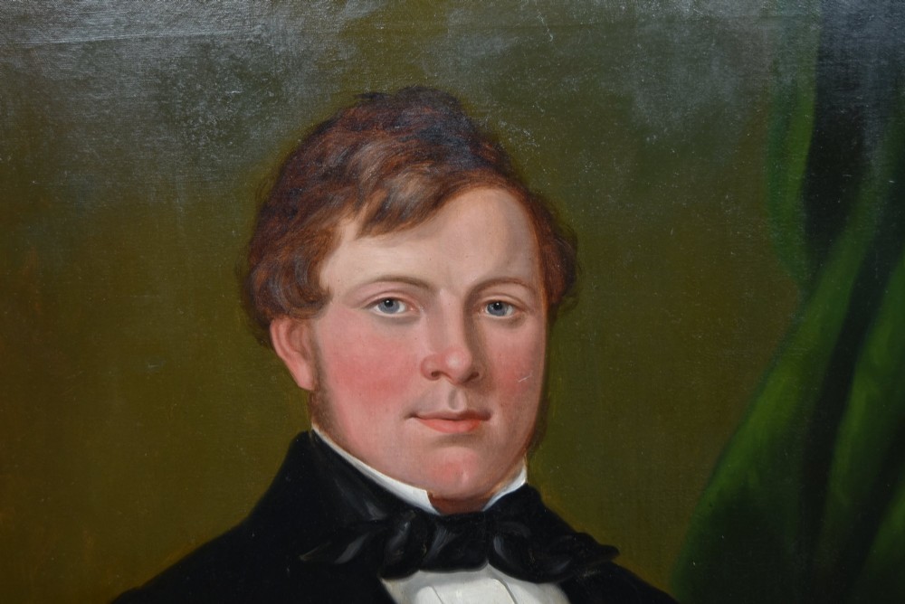 A nineteenth-century oil painting on canvas depicting a seated gentleman wearing a black jacket and white shirt, housed within a gilded wooden frame. View II