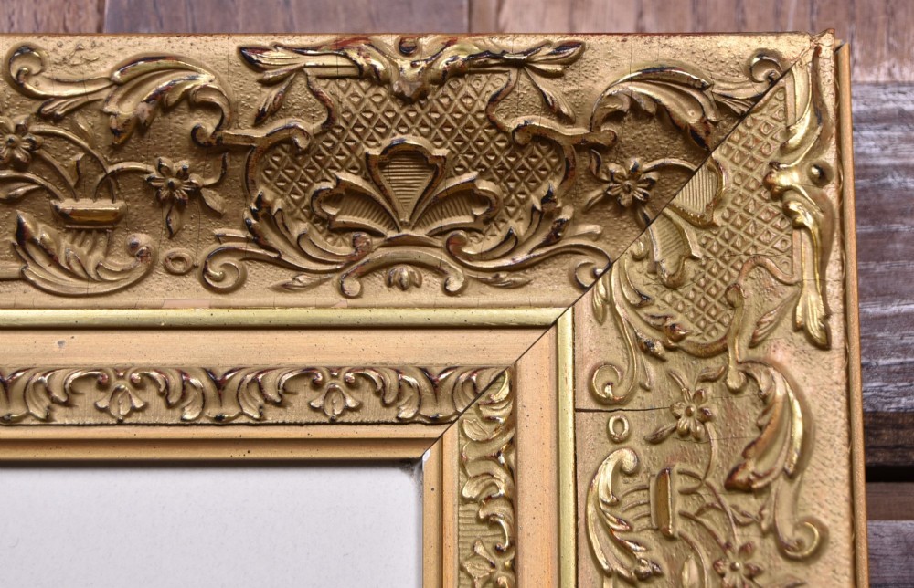 A framed monochrome print depicting a young violinist in period costume, set within a cream mount and an ornate gilded frame. View VI