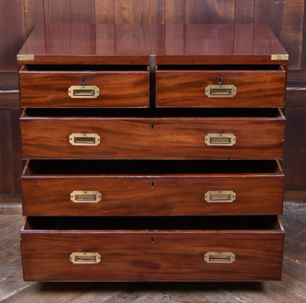 A 19th-century mahogany campaign chest of drawers featuring flush brass handles, corner brackets, and a two-section design. View V